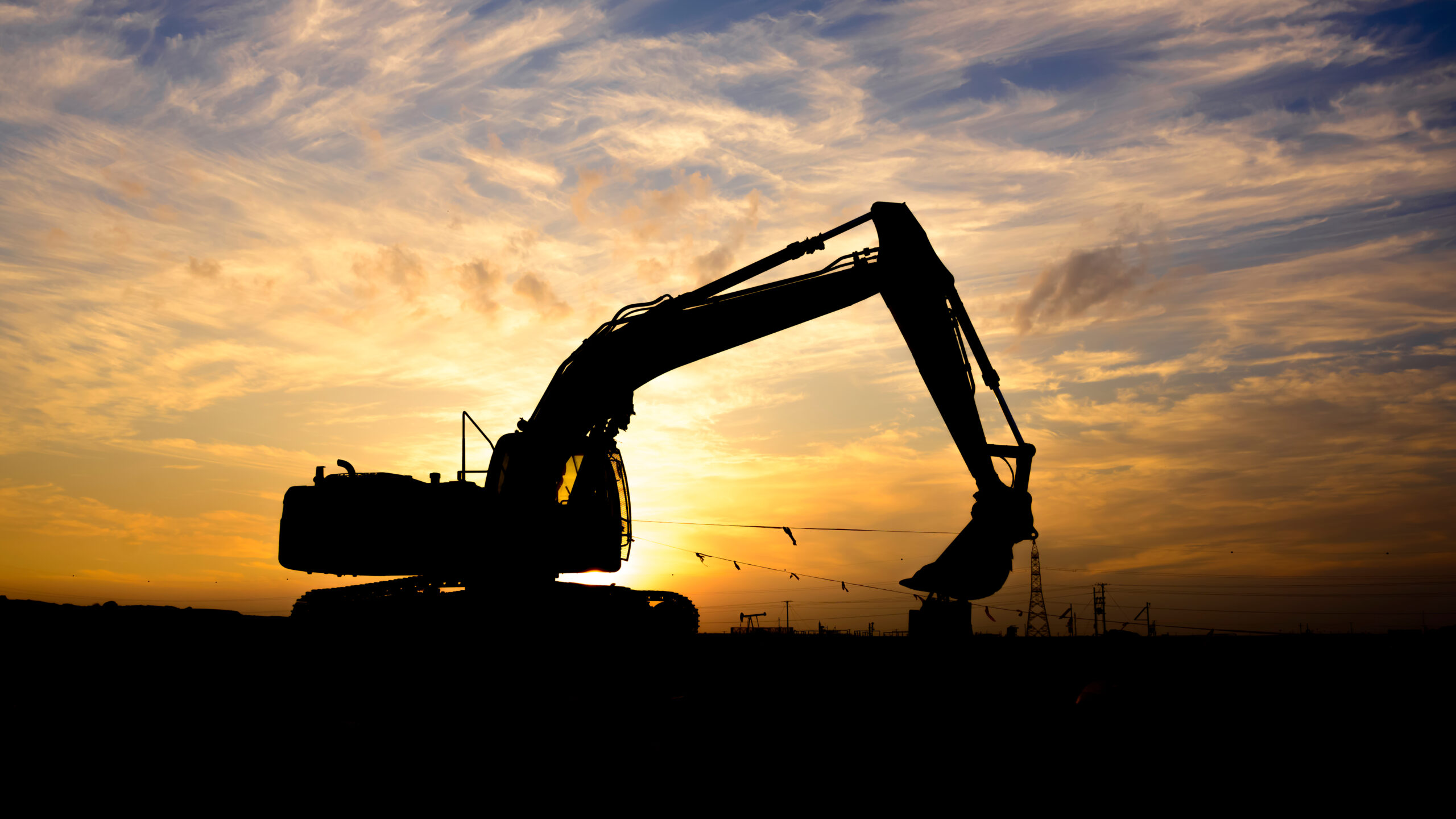 Silhouette,Of,Rock,Breaker,At,Sunset,In,Oilfield-,Underexposed,Image